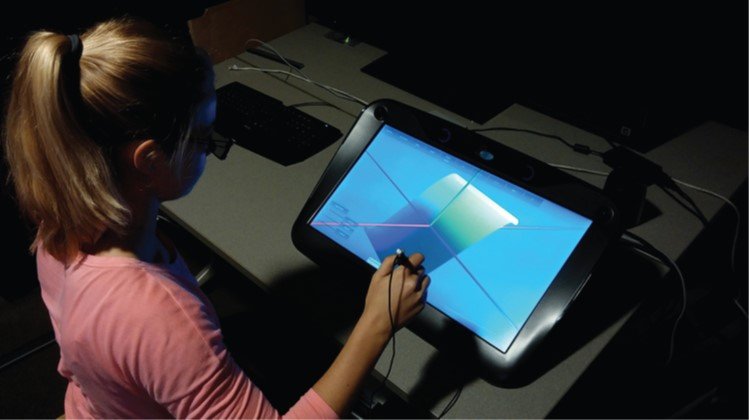 A person using a zSpace personalized, head-tracked stereo workbench with a stylus.